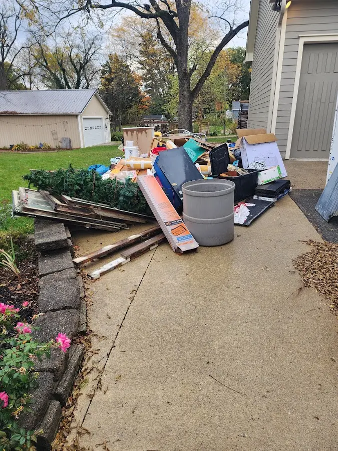 Dumpster being loaded with debris for Demolition Dumpster Rental in Covington
